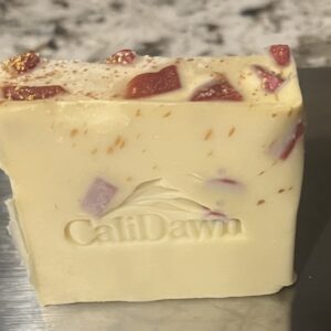 tan soap with small burgundy chunks inserted with gold sprinkles