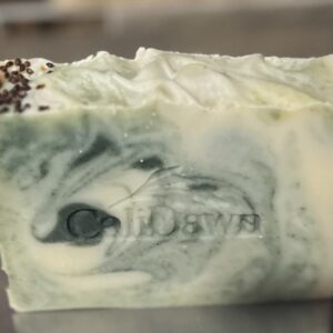 Soap bar with green and tan swirls topped with cranberry seeds