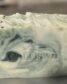 Soap bar with green and tan swirls topped with cranberry seeds